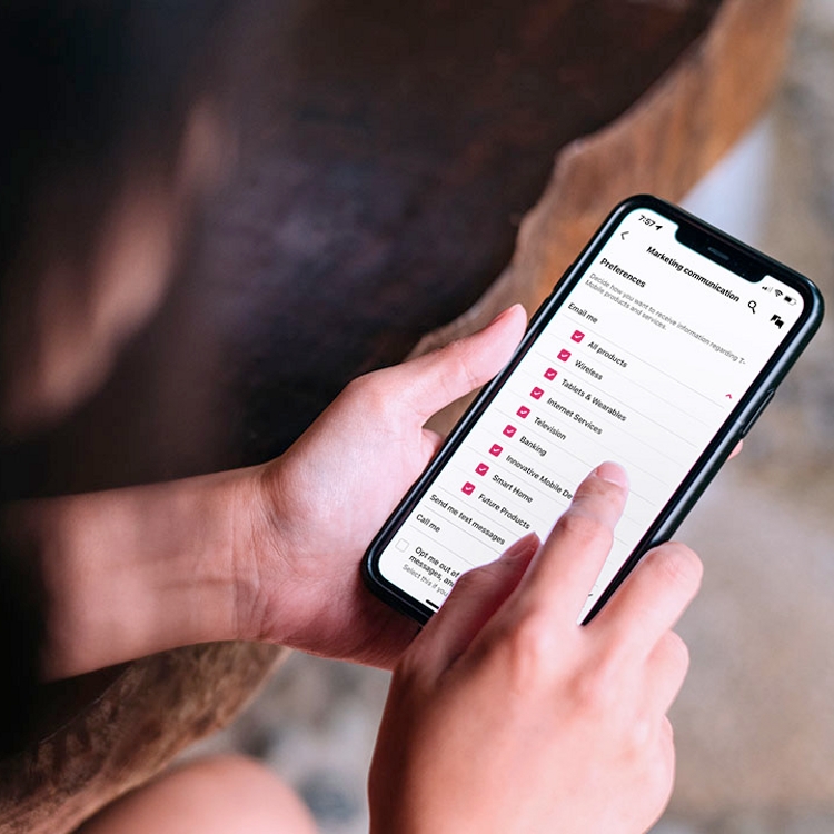 Person entering personal information into their mobile device.